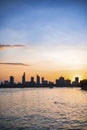 River city view landscape at twilight sunset. Boat on river with tranquil water. Hochiminh city Saigon vietnam cityscape building Royalty Free Stock Photo