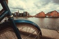 River and cityscape with old buildings and parked bicycle in Copenhagen, Denmark. Danish capital under clouds