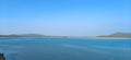 River with clear blue sky and green forest background, blue lake panoramic view Royalty Free Stock Photo