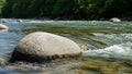 River with clear flowing water surrounded by smooth rounded stones Royalty Free Stock Photo