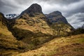 River Coe flows through Glen Coe with The Three Sisters mountains in early spring, Scotland Royalty Free Stock Photo