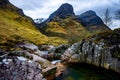 River Coe flows through Glen Coe with The Three Sisters mountains in early spring, Scotland Royalty Free Stock Photo