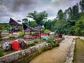 River with colorful Batak resting pavillons (Aek Situmandi), Tarutung, North Sumatra, Indonesia