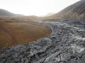 A river of cooled down lava turned into black volcanic rocks near Geldingadalir active Volcano