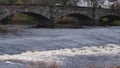 River Cree flowing over the weir at the Cree Bridge in Newton Stewart in winter