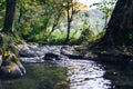 A river creek with a small waterfall. Sunset and strong detail bokeh view. blue calm warm water