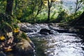 A river creek with a small waterfall. Sunset and strong detail bokeh view. blue calm warm water Royalty Free Stock Photo