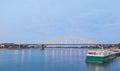 River cruise against Waal bridge at dusk