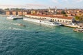 A river cruise boat docks at a port in Venice with the large cruise ships seen in the distance behind at the main ship port. Royalty Free Stock Photo