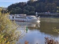 River cruise ship on Danube river near Passau city, Bavaria, Germany.White river boat with forest background Royalty Free Stock Photo