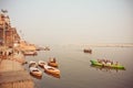 River dock area with riverboats at evening on sacred river Ganges Royalty Free Stock Photo