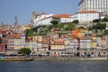 Porto panoramic landmark with boats on sunny day. Old buildings with brick roofs by river Douro in Porto, Portugal. Royalty Free Stock Photo