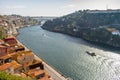 River Douro with embankment of Porto and boats. Old buildings with brick roofs by river Douro in Porto, Portugal. Royalty Free Stock Photo