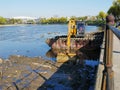 River dredging with tracked excavator