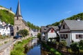 River elz with half-timbered houses and church in Monreal