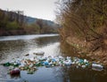 River with Floating Plastic Bottles and Bags Royalty Free Stock Photo