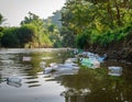 River with Floating Plastic Bottles and Bags Royalty Free Stock Photo