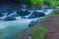 River flow contained black stones and moss Royalty Free Stock Photo