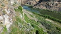 River flowing along the cliffs overgrown with vegetation Royalty Free Stock Photo