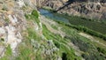 River flowing along the cliffs overgrown with vegetation Royalty Free Stock Photo