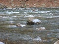 River Flowing Around Boulders in Winter