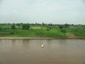 A river flowing through green fields in Burhanpur Royalty Free Stock Photo