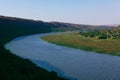 River flowing near green hill