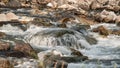 River flowing over rocks cascade on sunny day, closeup detail - longer exposure photo