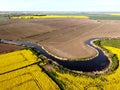 River flowing among rapeseed fields on Zulawy Wislane