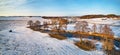 River flowing in snowy winter fields in wilderness at sunset. Stream meandering frosty countryside on cold evening. Aerial view of Royalty Free Stock Photo