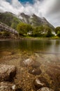Eidfjord river flowing through the town, mountains covered in the clouds in the background Royalty Free Stock Photo