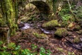 River flowing under old bridge