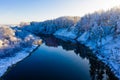 River flows along countryside on frosty morning, winter landscape. Trees after snowfall scenery Royalty Free Stock Photo