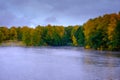 The river flows through the autumn forest. Royalty Free Stock Photo