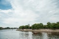 The river flows through the city. Church on the hill above the river. Wisla River in Krakow. Float the boat and the ship Royalty Free Stock Photo