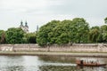 The river flows through the city. Church on the hill above the river. Wisla River in Krakow. Float the boat and the ship Royalty Free Stock Photo