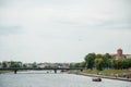 The river flows through the city. Church on the hill above the river. Wisla River in Krakow. Float the boat and the ship Royalty Free Stock Photo