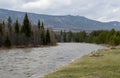 The river flows at the foot of the mountain ridge Royalty Free Stock Photo