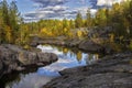 The river flows among the rocks and forest of the taiga