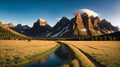 A river flows through yellow grasslands, with tall mountains and blue sky as the backdrop Royalty Free Stock Photo