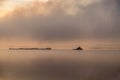 River in the fog, just before sunrise.Warm glow in the clouds from the first sunrays. Royalty Free Stock Photo