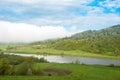 The river at the foot of the river. Giant cloud. Carpathians, Ukraine.