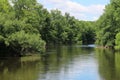 River forest view tree lined reflection blue sky Royalty Free Stock Photo