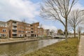 the canal in front of a row of apartment buildings Royalty Free Stock Photo