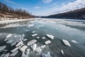 river frozen over with crystal-clear ice, surrounded by snowy landscape