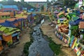 A river going thru the colorful village of Jodipan