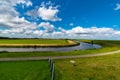 River in grassland on a sunny and cloudy day Royalty Free Stock Photo