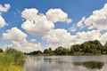 River, green grass and trees, blue sky with white clouds Royalty Free Stock Photo