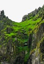 Wild Atlantic Way Ireland: Spectacular river of green spills over inhospitable craggy rock Skellig Michael Great Skellig Royalty Free Stock Photo