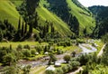 The river and herdsmen\'s yurts under the green hillside